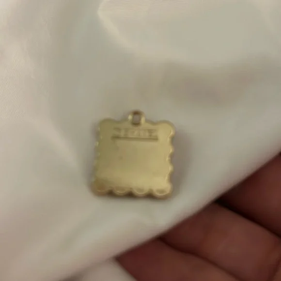 CHANEL Black and Gold Emblem pendant